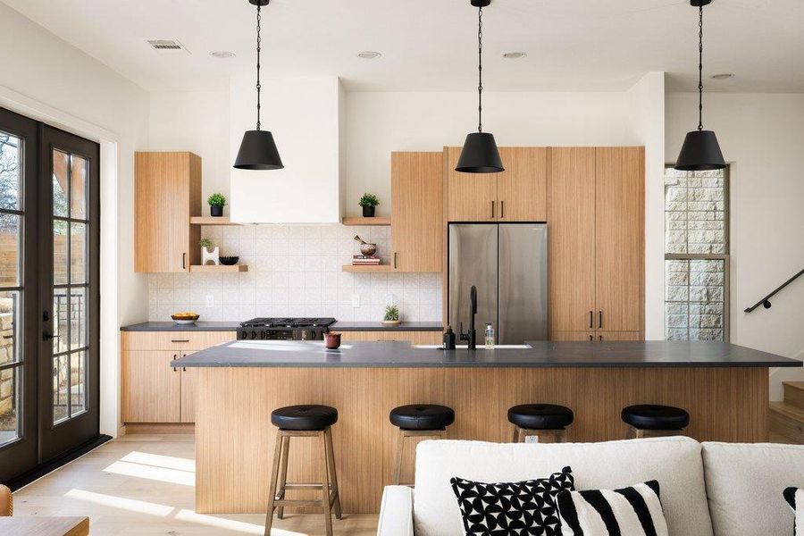 Kitchen has Quartz counters, open shelving, island with Farmhouse-style sink, light wood finish cabinets and stainless appliances. Kitchen has Quartz counters, open shelving, island with Farmhouse-style sink, light wood finish cabinets and stainless appliances.