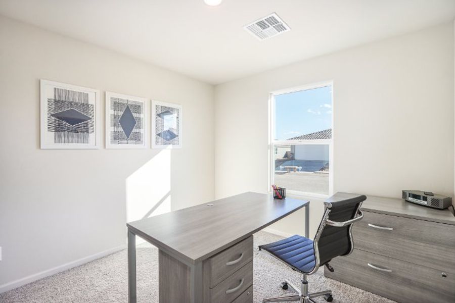 An office with a desk and a chair.