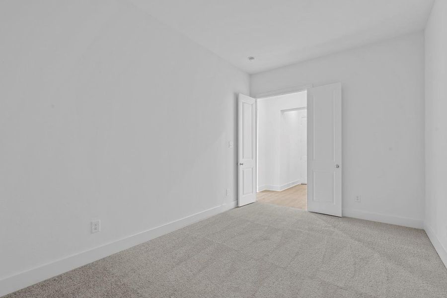 Carpeted empty room featuring baseboards Carpeted empty room featuring baseboards