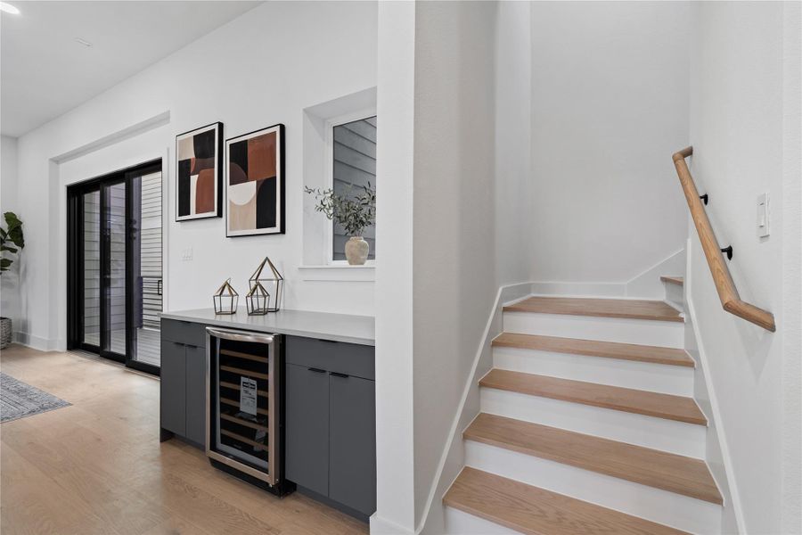 An elegant moment of transition, where modern millwork and warm wood stairs guide the eye upward. Artful accents and subtle contrast turn a passageway into a design statement.