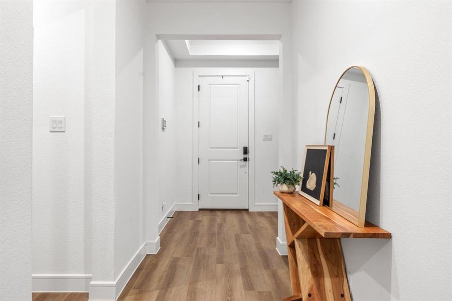 Doorway featuring wood finished floors and baseboards