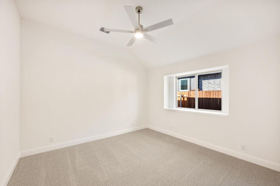 Empty bedroom with carpet flooring, white walls, ceiling fan, and a single window Empty bedroom with carpet flooring, white walls, ceiling fan, and a single window