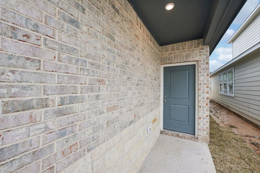 This home's distinctive blend of brick and stone elements enhances its exterior's character and appeal.