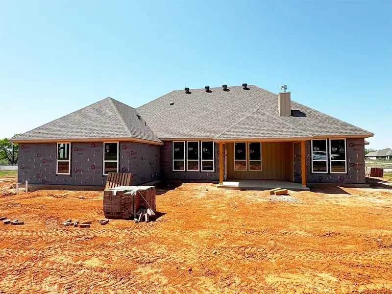 Rear view of house featuring a chimney, roof with shingles, and a patio Rear view of house featuring a chimney, roof with shingles, and a patio
