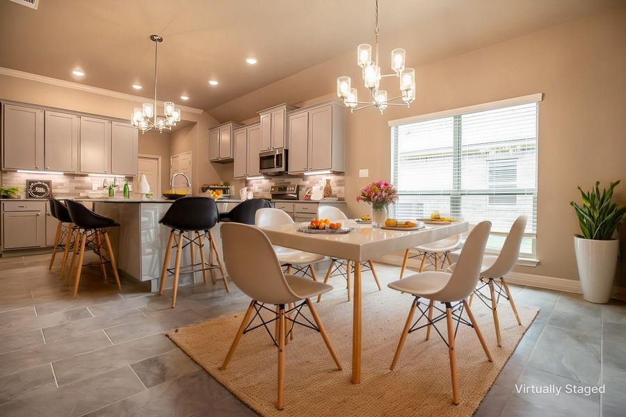 Dining room featuring a chandelier, visible vents, lofted ceiling, ornamental molding, and recessed lighting