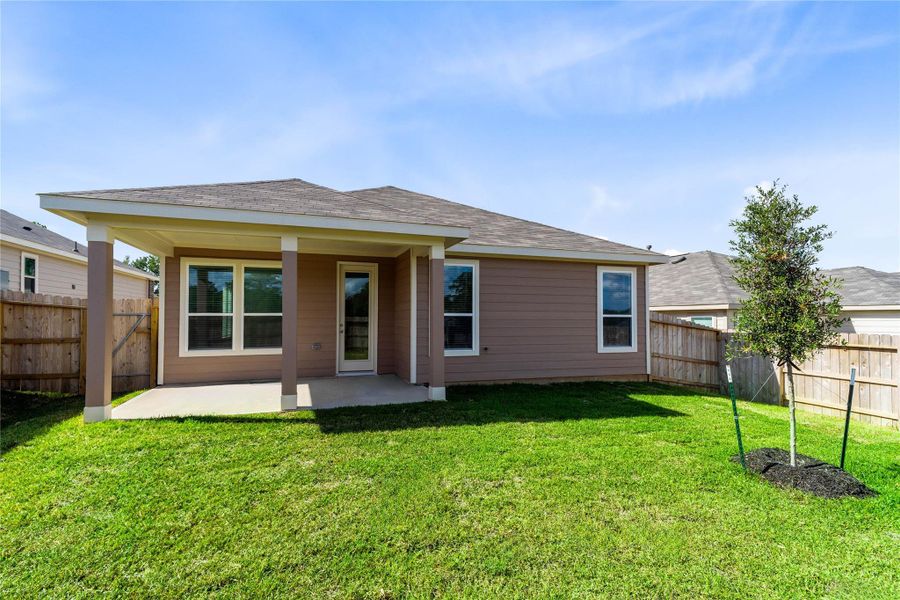 Step outside to the inviting covered patio overlooking the private, fenced backyard with ample green space.