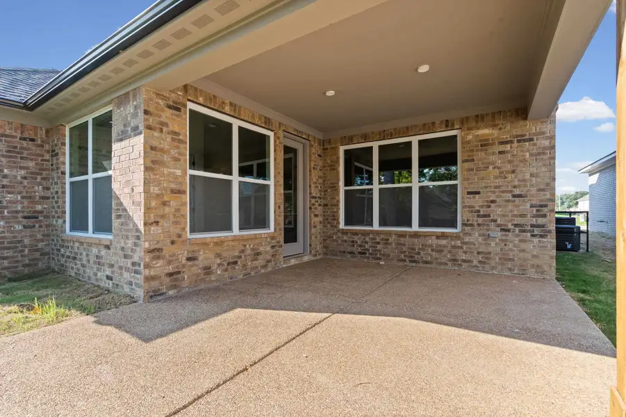 Covered patio with recessed lighting, brick exterior, and multiple large windows Covered patio with recessed lighting, brick exterior, and multiple large windows
