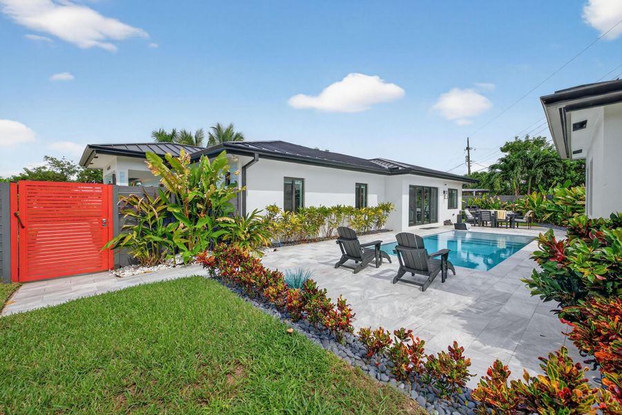 View from South East corner of the property, red gate opens to front driveway, two guest bedroom windows facing pool, wall on the right is the 12 x 12 pool house View from South East corner of the property, red gate opens to front driveway, two guest bedroom windows facing pool, wall on the right is the 12 x 12 pool house