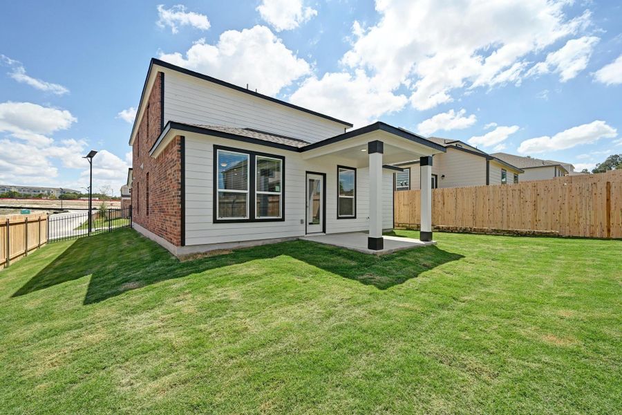 Front exterior of a new home in Creekside at Estancia, Austin, TX, highlighting curb appeal (Image 18).