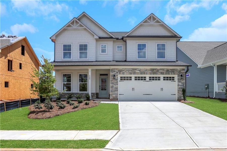 Front exterior of a new home in Twin Lakes, Hoschton, GA, highlighting curb appeal (Image 26). Front exterior of a new home in Twin Lakes, Hoschton, GA, highlighting curb appeal (Image 26).