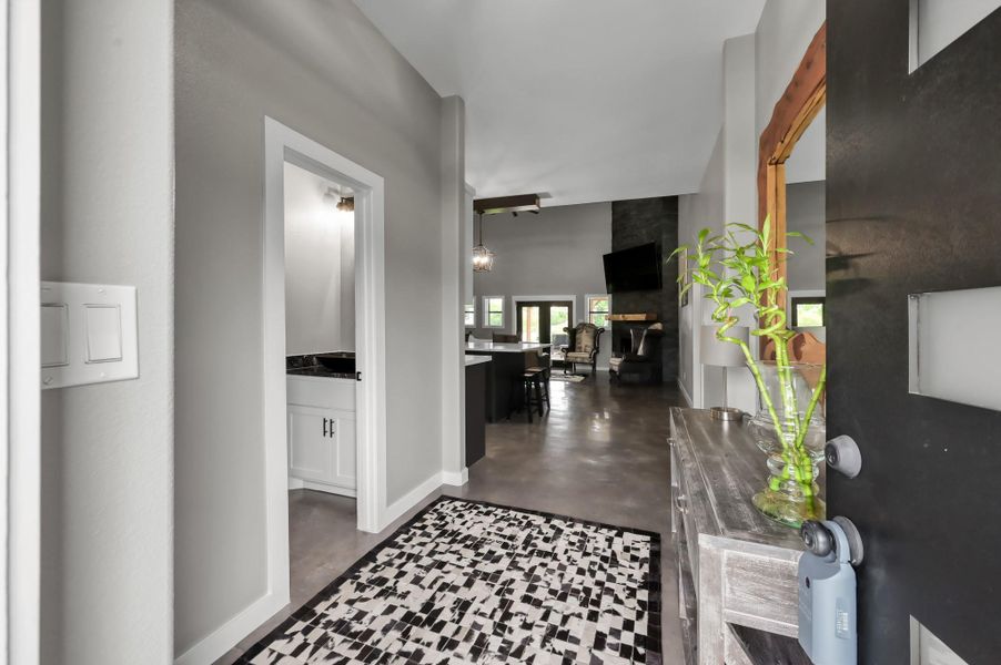This welcoming entryway features a modern, open-concept design with neutral walls and sleek flooring.