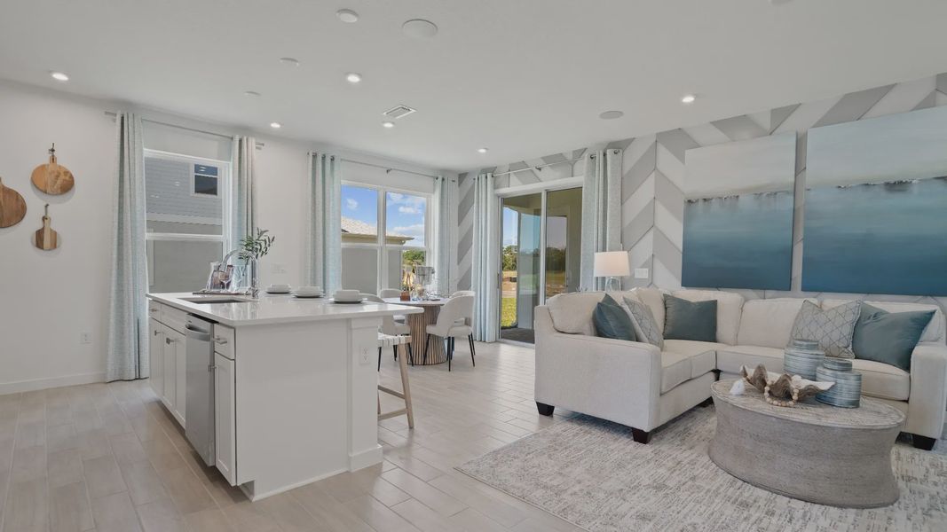 Open kitchen and family room at a DRB Homes Ambersweet model at the Trinity Place community. Open kitchen and family room at a DRB Homes Ambersweet model at the Trinity Place community.