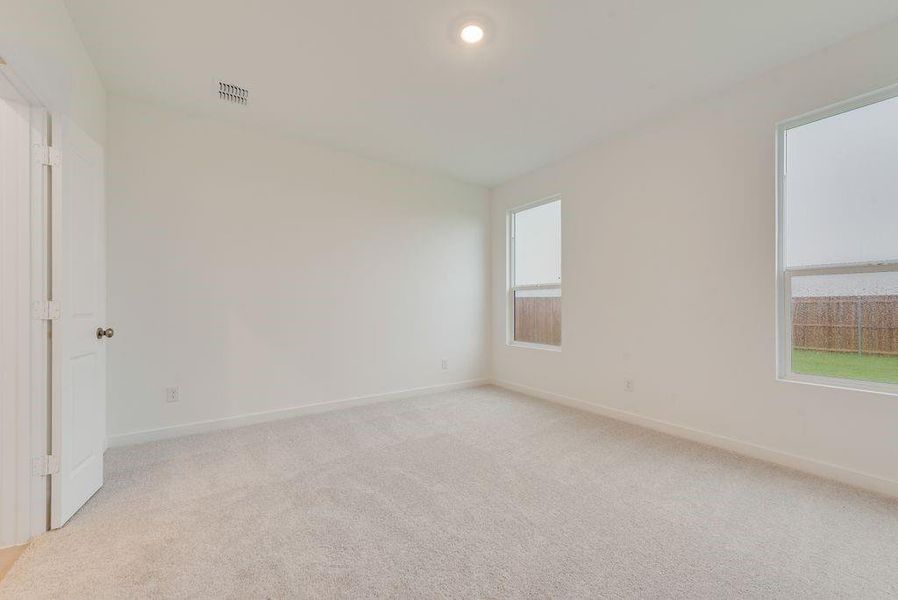 Unfurnished room with light colored carpet and recessed lighting Unfurnished room with light colored carpet and recessed lighting