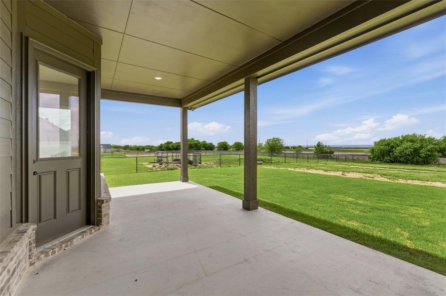 Fenced backyard with a patio and a view of rural / pastoral area Fenced backyard with a patio and a view of rural / pastoral area