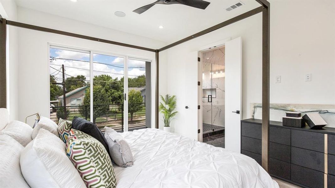 Bedroom with access to outside, ensuite bathroom, and ceiling fan