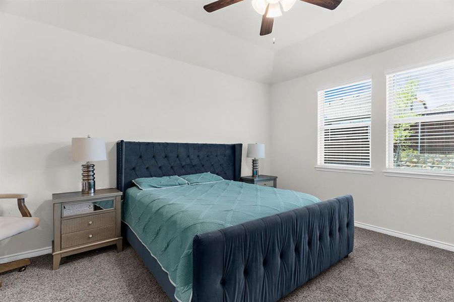 Bedroom featuring a ceiling fan, carpet floors, and baseboards