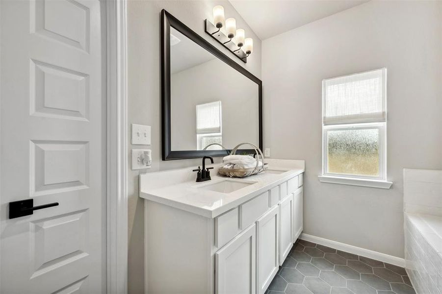 Relaxing owner's bath with double sinks (*Photo not of actual home and used for illustration purposes only.)