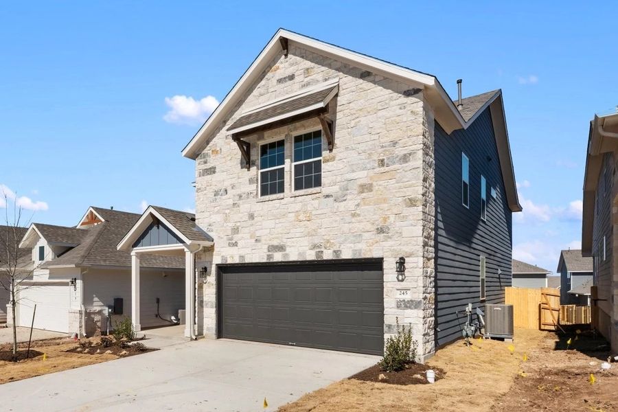 Front exterior of a new home in Cannon Ranch, Dripping Springs, TX, highlighting curb appeal (Image 26).