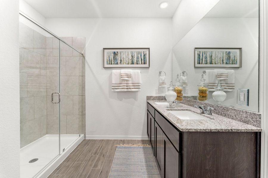 A bathroom with a glass shower. A bathroom with a glass shower.