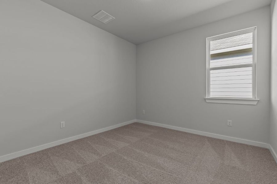 A room with a window and a carpet.