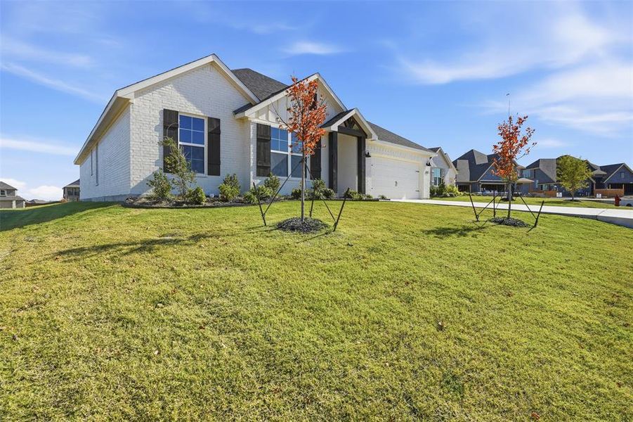 Front exterior of a new home in Wildcat Ridge, Godley, TX, highlighting curb appeal (Image 20). Front exterior of a new home in Wildcat Ridge, Godley, TX, highlighting curb appeal (Image 20).