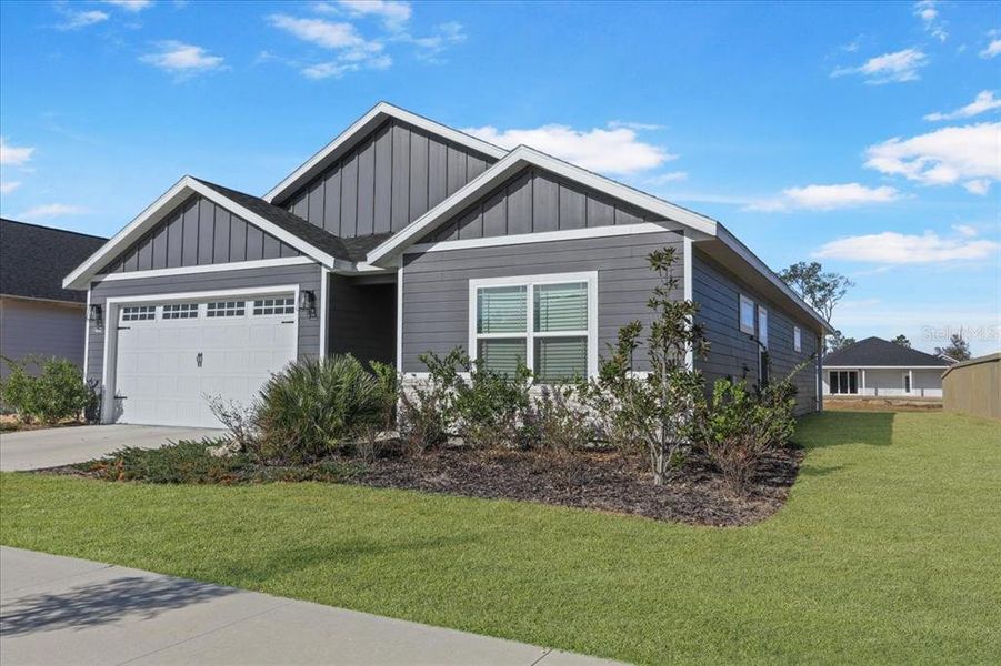 Front exterior of a new home in Grand Oaks, Gainesville, FL, highlighting curb appeal (Image 23).