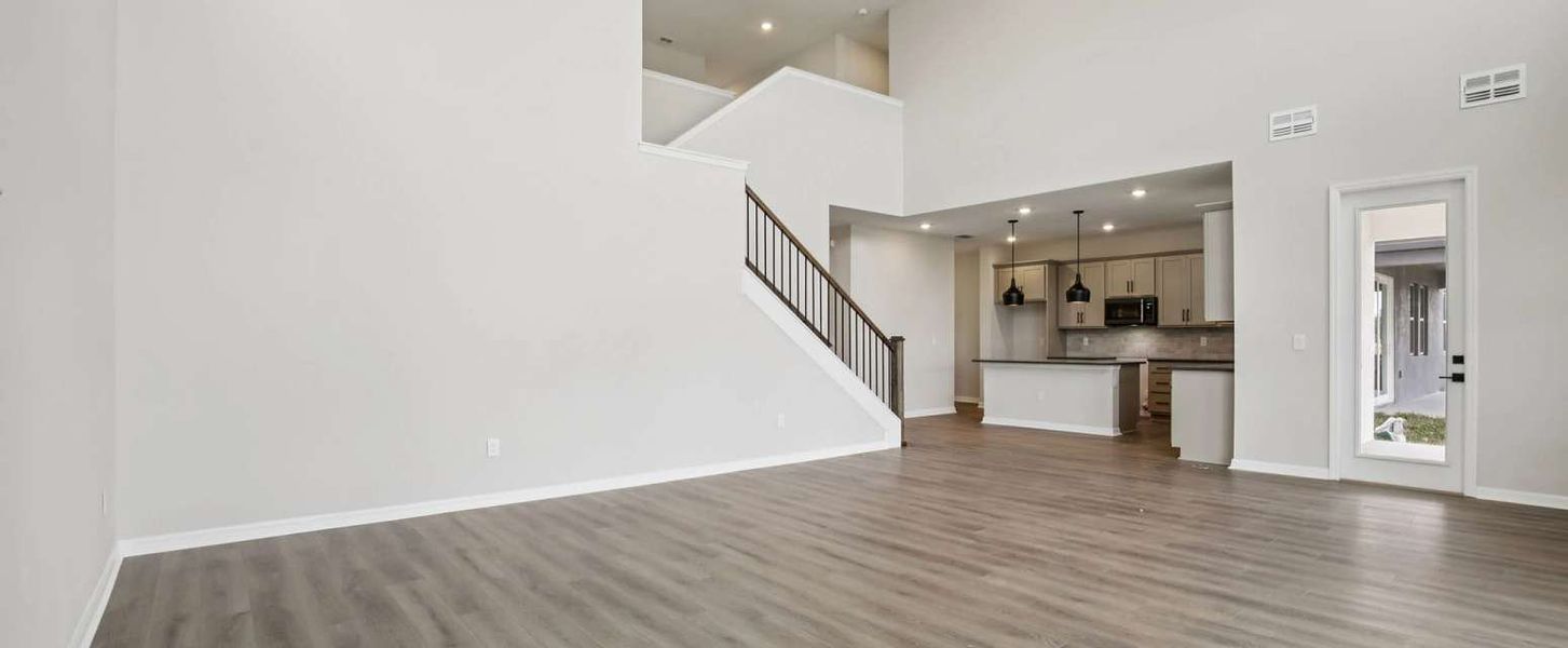 Two-story great room and stair spindles with railing - representative image this home will feature AW Collection® Laguna Two-story great room and stair spindles with railing - representative image this home will feature AW Collection® Laguna