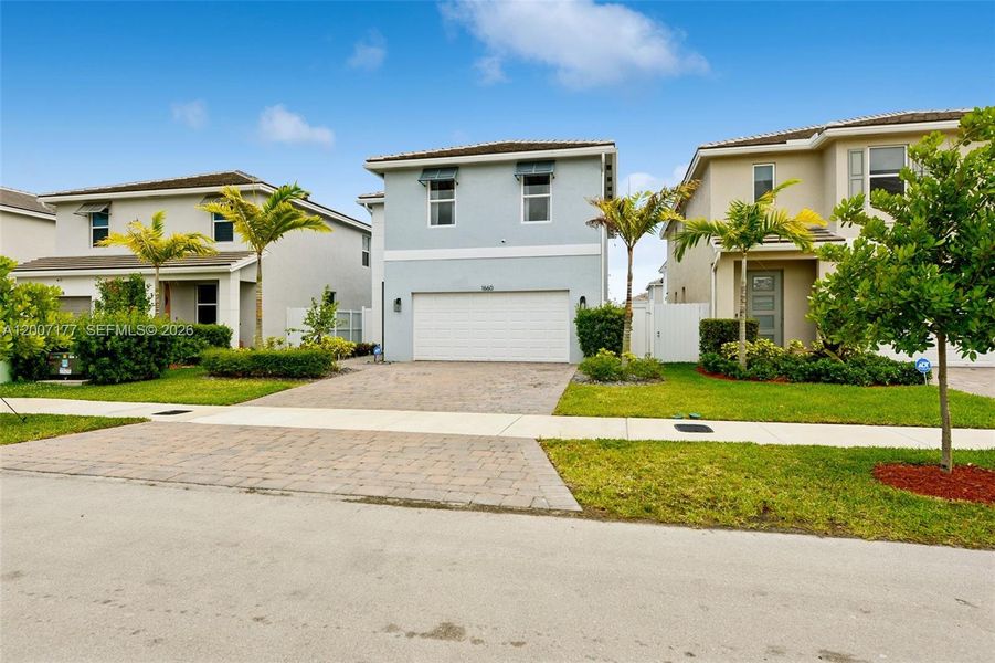 Front exterior of a new home in Messina Place, Homestead, FL, highlighting curb appeal (Image 24).