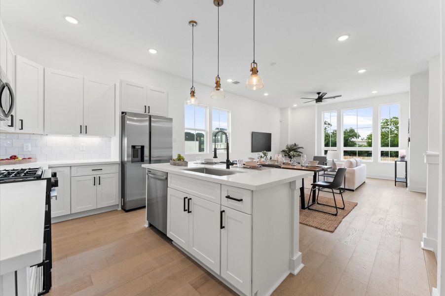This stylish kitchen features sleek quartz countertops that offer both durability and elegance, paired with a spacious center island perfect for meal prep and casual dining. Surrounding the space is a generous array of cabinets, providing ample storage while maintaining a clean, streamlined look. The open layout and contemporary finishes create a welcoming atmosphere ideal for both everyday living and entertaining.