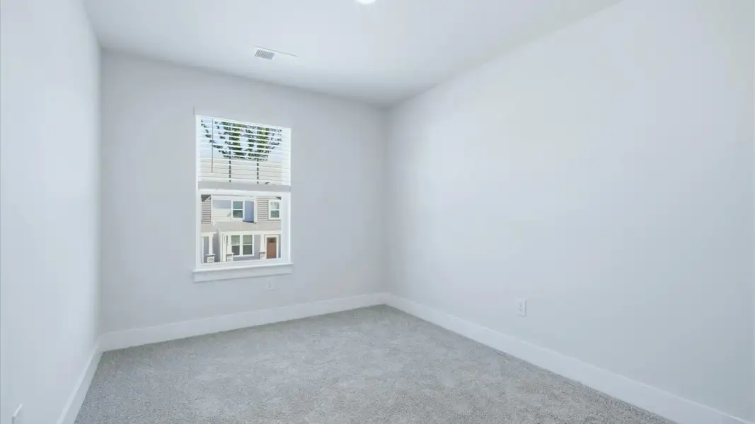 First-rate bedroom with plush carpeting and a large window that provides an open, airy feel near Lake Hartwell