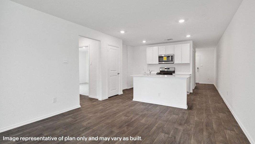 Kitchen with light countertops, an island with sink, white cabinetry, dark wood-style flooring, and recessed lighting Kitchen with light countertops, an island with sink, white cabinetry, dark wood-style flooring, and recessed lighting
