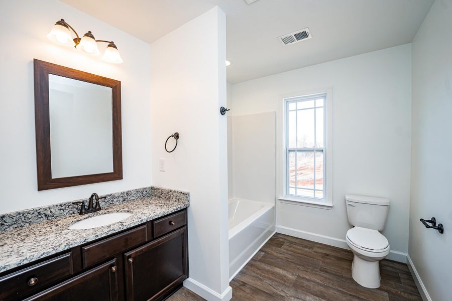 Representative furnished interior of a home built from the Sumter by Enchanted Homes in Ballentine Ridge, Lyman (Image 13).