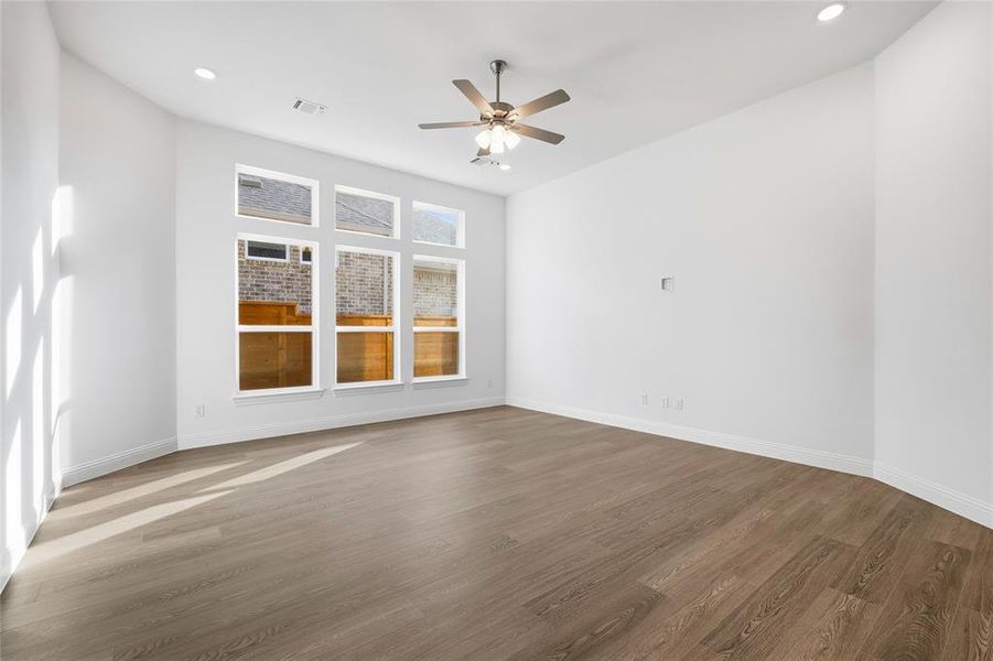 Spare room with wood finished floors, recessed lighting, and ceiling fan