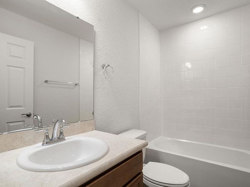 This home also has an upstairs hall bath and a downstairs powder room.