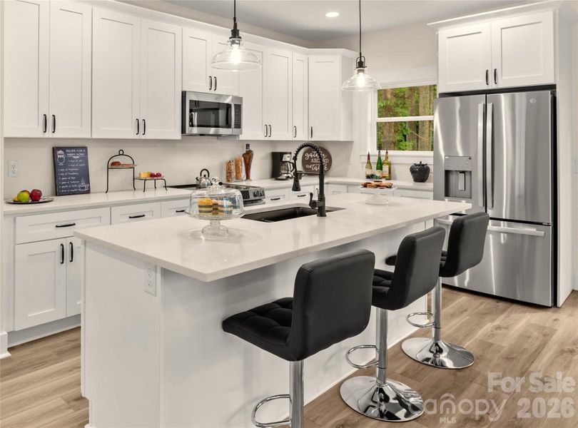Gourmet Kitchen with quartz counters, stainless appliances to include refrigerator & large island.