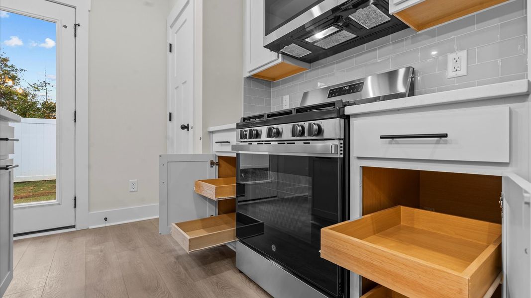 Memorable meals begin in this vibrant kitchen with pendant lighting and a thoughtfully designed island
