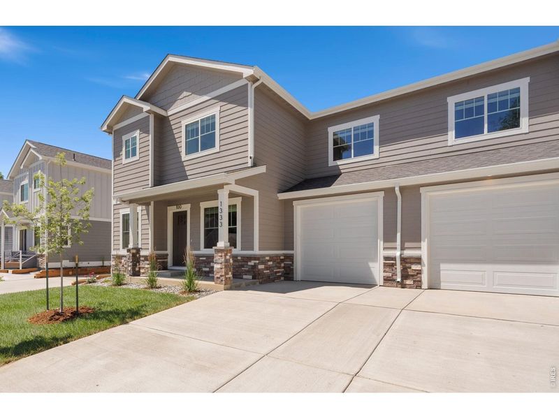 Front exterior of a new home in , Loveland, CO, highlighting curb appeal (Image 1). Front exterior of a new home in , Loveland, CO, highlighting curb appeal (Image 1).