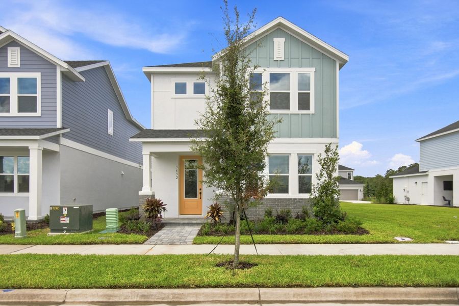 Front exterior of a new home in Palmeras at Crossprairie – The Magnolia Collection, St. Cloud, FL, highlighting curb appeal (Image 2). Front exterior of a new home in Palmeras at Crossprairie – The Magnolia Collection, St. Cloud, FL, highlighting curb appeal (Image 2).