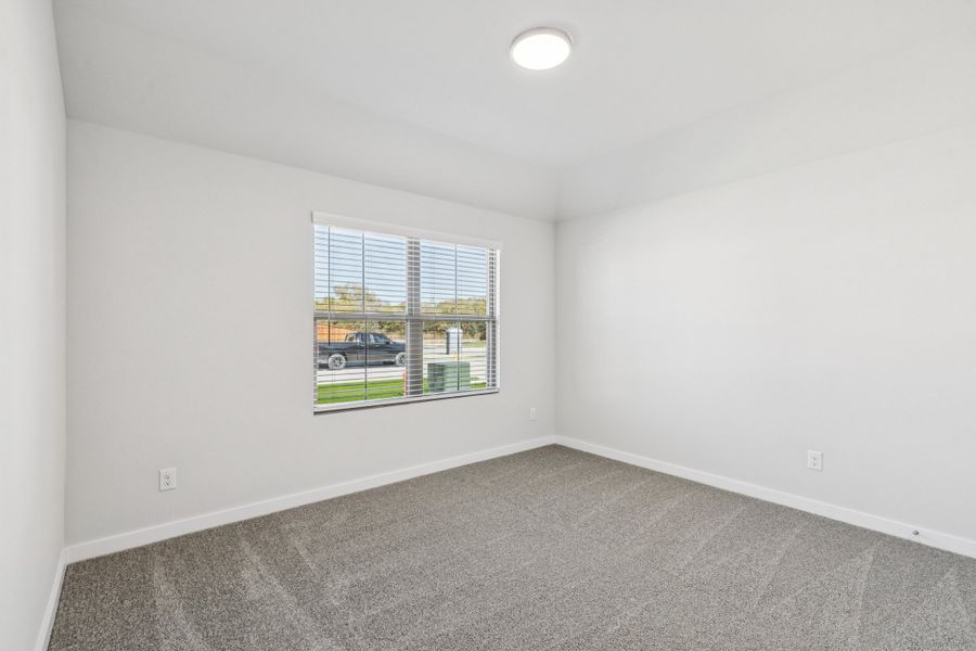 Bedroom in the Oscar home plan by Trophy Signature Homes – REPRESENTATIVE PHOTO