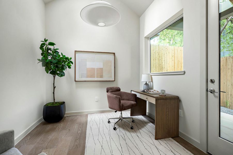 Office featuring lofted ceiling and a skylight
