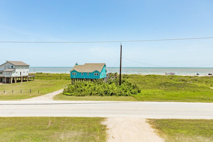 Enjoy views of the Gulf and surrounding beach homes from the elevated front balcony, offering a scenic coastal backdrop.