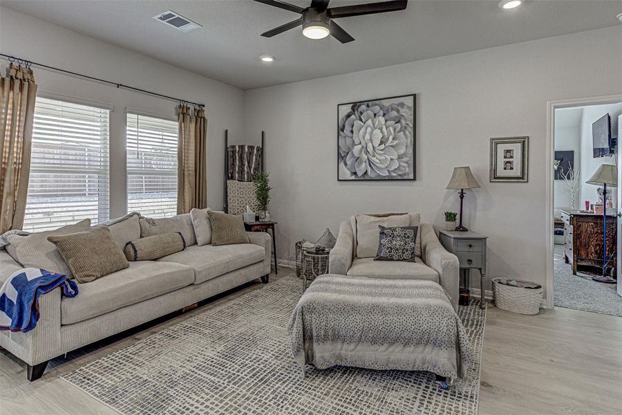 Living area featuring a ceiling fan, light wood-style flooring, and recessed lighting