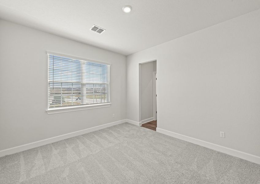 Secondary bedroom with lush carpet flooring