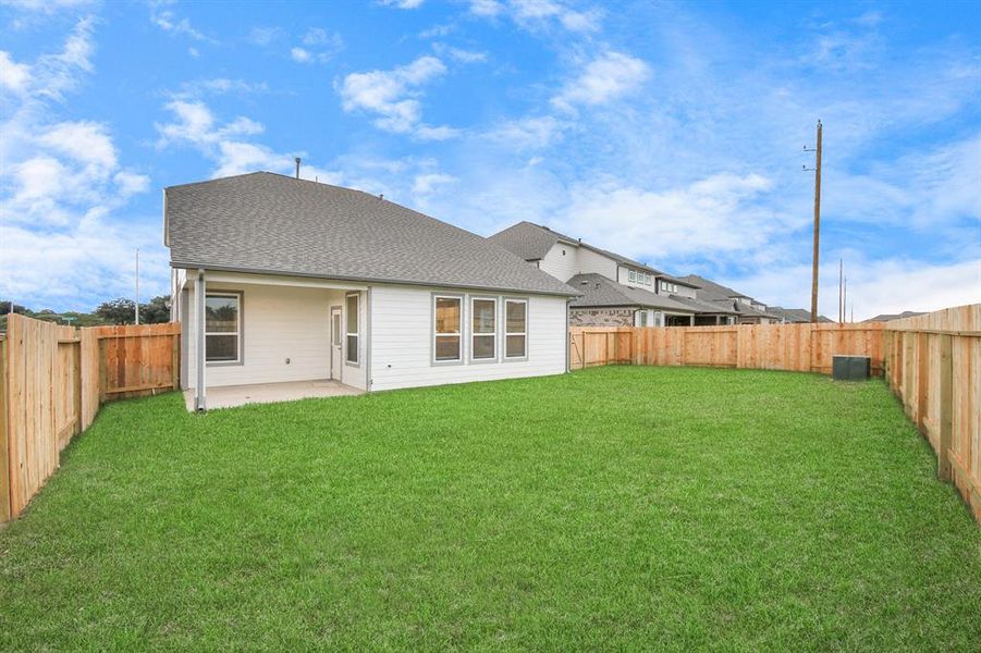 Step into a world of outdoor possibilities with this remarkable backyard and its charming covered patio. From playtime for the kids to relaxation for the adults, this space offers the best of both worlds.