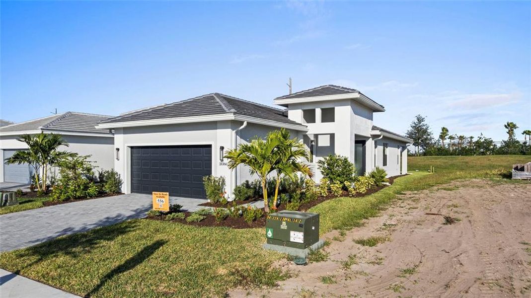Front exterior of a new home in Cresswind Lakewood Ranch, Lakewood Ranch, FL, highlighting curb appeal (Image 1). Front exterior of a new home in Cresswind Lakewood Ranch, Lakewood Ranch, FL, highlighting curb appeal (Image 1).