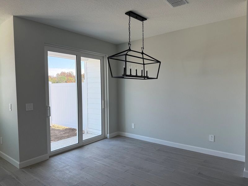 Generous dining space with easy access to back patio