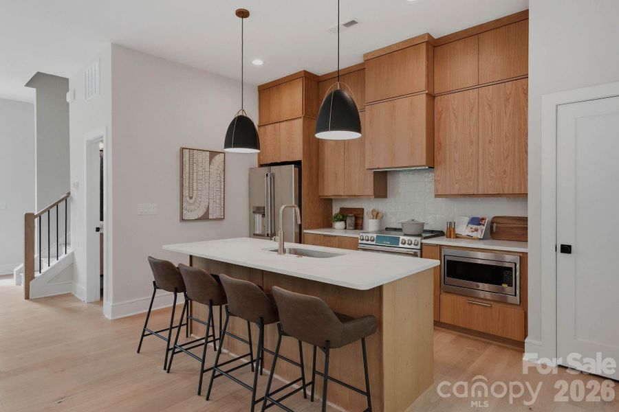 Custom white oak cabinetry with GE Cafe Series appliances