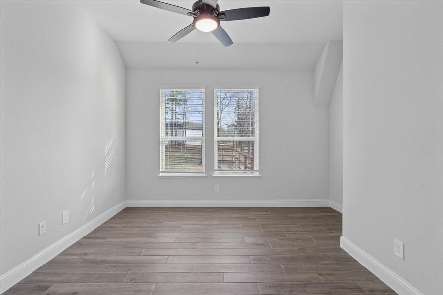 This handsome home office features wood-look tile flooring, high sloped ceilings with ceiling fan, large windows with privacy blinds, and custom paint! This handsome home office features wood-look tile flooring, high sloped ceilings with ceiling fan, large windows with privacy blinds, and custom paint!