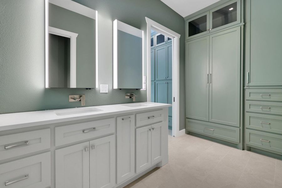 The primary bathroom features custom built-ins, heated floors, a luxurious steam shower, comfort-height toilet, and hand-held shower heads = spa-like relaxation.