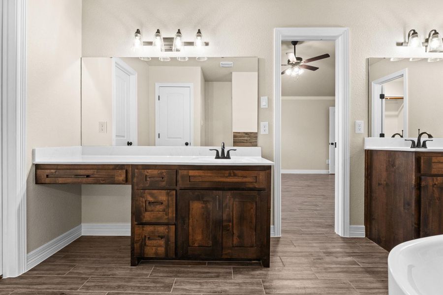 Full bath with wood like tile floors, two vanities, walk-in shower, and a soaking tub Full bath with wood like tile floors, two vanities, walk-in shower, and a soaking tub